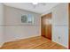 Bedroom with wood floors, closet, and window with blinds at 7425 S Dexter St, Centennial, CO 80122