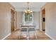 Dining room with hardwood floors, a classic chandelier, natural light, and seating for six at 7425 S Dexter St, Centennial, CO 80122