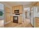Cozy kitchen featuring light wood cabinets, laminate flooring, and modern appliances at 7425 S Dexter St, Centennial, CO 80122