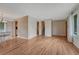 Bright open-concept living area with hardwood floors, stairs, and views into the kitchen and dining room at 7425 S Dexter St, Centennial, CO 80122