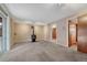 Spacious living room with soft carpet, a cozy wood-burning stove, and sliding door to the deck at 7425 S Dexter St, Centennial, CO 80122