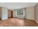 Cozy living room with hardwood floors, white walls, a large window, and natural light at 7425 S Dexter St, Centennial, CO 80122