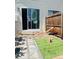 Backyard featuring a stone walkway, artificial grass, and a sliding glass door to the house at 12225 E 2Nd Dr, Aurora, CO 80011