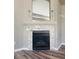 Cozy fireplace with herringbone floors and a decorative mirror above the mantle at 12225 E 2Nd Dr, Aurora, CO 80011