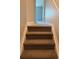 Carpeted staircase leading upstairs with a glimpse of an open room at 12225 E 2Nd Dr, Aurora, CO 80011