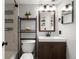 Bright bathroom features a modern vanity, sleek fixtures, and a decorative shelving unit for storage and décor at 12476 W Nevada Pl # 106, Lakewood, CO 80228