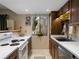Bright kitchen with stainless steel appliances, white counter tops, and view to the outdoor greenery at 12476 W Nevada Pl # 106, Lakewood, CO 80228