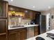 Kitchen featuring stainless steel appliances, light countertops, and wood cabinets at 12476 W Nevada Pl # 106, Lakewood, CO 80228