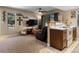 Cozy living room features a ceiling fan, TV, and adjoining kitchen bar with range at 12476 W Nevada Pl # 106, Lakewood, CO 80228