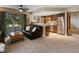Inviting living room with view to patio, flowing into the kitchen featuring stainless steel appliances and warm wood cabinetry at 12476 W Nevada Pl # 106, Lakewood, CO 80228