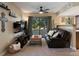 Comfortable living room with natural light, cozy seating, and a serene view of the trees outside at 12476 W Nevada Pl # 106, Lakewood, CO 80228