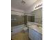 Well-lit bathroom with shower-tub combo, cream tile flooring and ample space at 8791 Chase Dr # 220, Arvada, CO 80003