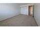 Neutral carpeted bedroom featuring closet and white walls at 8791 Chase Dr # 220, Arvada, CO 80003