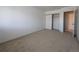 Neutral carpeted bedroom featuring closet and white walls at 8791 Chase Dr # 220, Arvada, CO 80003