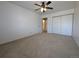 Spacious carpeted bedroom features a ceiling fan, a double closet, and a door to the bathroom at 8791 Chase Dr # 220, Arvada, CO 80003