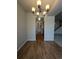 Inviting dining area showcasing wood floors, stylish lighting, and convenient access to the kitchen and staircase at 8791 Chase Dr # 220, Arvada, CO 80003