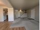 Bright and spacious living room features neutral paint, carpet, and stair access at 8791 Chase Dr # 220, Arvada, CO 80003
