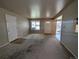 Bright and airy living room with multiple entrances and windows, plus neutral carpet and paint at 8791 Chase Dr # 220, Arvada, CO 80003