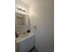 Clean powder room with single sink, cabinet and vanity lighting at 8791 Chase Dr # 220, Arvada, CO 80003