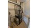 Close-up of a utility closet housing a furnace with visible ductwork and a water heater at 8791 Chase Dr # 220, Arvada, CO 80003