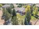 Aerial view of home featuring mature trees, green grass, outdoor living space and perimeter fence at 18399 Wagon Trl, Mead, CO 80542