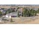 Rear aerial view of a brick home featuring an attached three-car garage and fenced in area at 18399 Wagon Trl, Mead, CO 80542