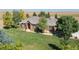 Beautiful aerial view of a well-kept brick home with an expansive green lawn at 18399 Wagon Trl, Mead, CO 80542