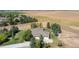 Aerial view of home with mature trees, large driveway and expansive fields nearby at 18399 Wagon Trl, Mead, CO 80542