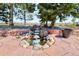 Backyard pond with rock waterfall and stone surround at 18399 Wagon Trl, Mead, CO 80542