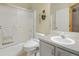 Well-lit bathroom with shower-tub combination, gray vanity with white sink, and updated toilet at 18399 Wagon Trl, Mead, CO 80542