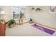 Bright room features a large window, neutral walls, and a yoga mat, creating a serene and inviting space at 18399 Wagon Trl, Mead, CO 80542