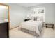 Neutral bedroom with a queen bed, neutral bedding, shuttered windows, and a dark wood dresser at 18399 Wagon Trl, Mead, CO 80542