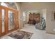Spacious foyer leading to a home office, featuring tile flooring and ample natural light at 18399 Wagon Trl, Mead, CO 80542