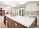 Modern kitchen island with quartz countertops and seating, adjacent to a cozy living area at 18399 Wagon Trl, Mead, CO 80542