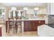 Beautiful kitchen with a large central island, chairs, and modern white countertops at 18399 Wagon Trl, Mead, CO 80542