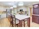 Kitchen features stainless appliances, white cabinets, and central island with bar stool seating at 18399 Wagon Trl, Mead, CO 80542