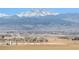 Expansive landscape view featuring rolling hills and snow-capped mountains in the background at 18399 Wagon Trl, Mead, CO 80542