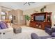 Bright living room with hardwood floors, comfortable seating, and a large entertainment unit at 18399 Wagon Trl, Mead, CO 80542