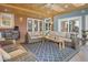 Spacious sunroom with comfortable seating, a ceiling fan, wood plank ceiling, and bright accents at 18399 Wagon Trl, Mead, CO 80542