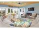 Cozy porch with wood ceiling, fireplace, ample seating, and view of the surrounding landscape at 18399 Wagon Trl, Mead, CO 80542