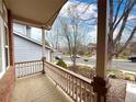 Cozy covered front porch showcasing the neighborhood street and mature trees at 13661 Adams St, Thornton, CO 80602
