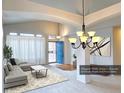Bright living room boasts large windows, neutral tones, stylish decor, and a striking blue front door at 13661 Adams St, Thornton, CO 80602
