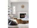 A closer view of the living room's fireplace, with white mantle and tiled hearth and modern accents at 1675 Newport St, Denver, CO 80220