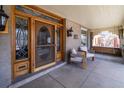Close-up of front porch featuring elegant entry door, swing, and seating, blending charm with modern comfort at 780 N Lafayette St, Denver, CO 80218