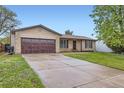 Well-maintained home featuring a spacious driveway and a two-car garage at 9134 Bellaire St, Thornton, CO 80229