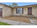 Close up of exterior with wood mulch landscaping, a window and a brown door at 9134 Bellaire St, Thornton, CO 80229