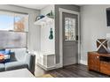 Bright living room area with stylish decor, modern flooring, and convenient entry access at 1678 Verbena St, Denver, CO 80220