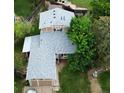 Aerial view of a two-story home with gray roof, well-maintained lawn, and a fenced backyard at 4677 S Salida St, Aurora, CO 80015