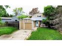 Charming two-story home with a front yard and driveway leading to an attached garage at 4677 S Salida St, Aurora, CO 80015