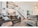 Spacious living room with high ceilings, staircase, open floor plan, and view to bedroom at 8391 W 90Th Pl, Westminster, CO 80021